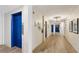 Hallway featuring light walls, wood-look floors, and access to the elevator at 841 4Th N Ave # 55, St Petersburg, FL 33701