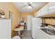 Cozy eat-in kitchen featuring white appliances, cabinets, and a ceiling fan at 841 4Th N Ave # 55, St Petersburg, FL 33701