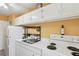 Functional kitchen with white cabinetry, an efficient layout, and modern appliances, providing a practical cooking space at 841 4Th N Ave # 55, St Petersburg, FL 33701