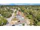 An aerial view of residential homes with mature trees lining the neighborhood with some landscaping and cars in driveways at 8433 101St Ave, Seminole, FL 33777