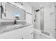 Modern bathroom with white marble countertops, sleek black fixtures, and glass-enclosed shower at 8433 101St Ave, Seminole, FL 33777