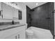 Modern bathroom featuring dark tiled shower and bath and white marble countertops at 8433 101St Ave, Seminole, FL 33777