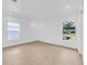Bright, empty bedroom with two windows and wood-look floors at 8433 101St Ave, Seminole, FL 33777