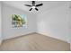 Bright bedroom boasts fresh paint, modern ceiling fan, wood-look flooring, and a window at 8433 101St Ave, Seminole, FL 33777