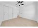 Clean bedroom with hardwood floors, white trim, ceiling fan, and double door closet at 8433 101St Ave, Seminole, FL 33777