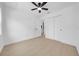Clean bedroom with hardwood floors, white trim, ceiling fan, and double door closet at 8433 101St Ave, Seminole, FL 33777