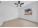Bright bedroom with fan and wood-look floors, complemented by a window view at 8433 101St Ave, Seminole, FL 33777