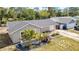 Charming single-story home features neutral paint, dark roof, and verdant landscaping at 8433 101St Ave, Seminole, FL 33777