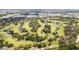 Scenic aerial shot of a lush green golf course with sand traps, trees, and picturesque water hazards on a sunny day at 8433 101St Ave, Seminole, FL 33777