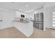 Bright kitchen featuring white cabinets, stone countertops, and stainless steel appliances at 8433 101St Ave, Seminole, FL 33777
