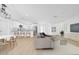 Bright, open-concept living space with modern furnishings, hardwood floors, and updated kitchen with stainless steel appliances at 8433 101St Ave, Seminole, FL 33777