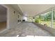 Spacious screened-in patio featuring neutral toned tiled flooring and tranquil backyard views at 8433 101St Ave, Seminole, FL 33777