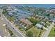 Aerial view of waterfront townhomes with lush landscaping, a community pool, and convenient canal access at 903 Pinellas Bayway S # 103, Tierra Verde, FL 33715