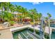 Waterfront backyard with lush landscaping, dock, and boat lift at 903 Pinellas Bayway S # 103, Tierra Verde, FL 33715