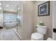 Bright bathroom with a modern soaking tub, glass shower, and shuttered window at 903 Pinellas Bayway S # 103, Tierra Verde, FL 33715