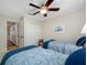 This bedroom features two twin beds, a ceiling fan, and a view to the hallway at 903 Pinellas Bayway S # 103, Tierra Verde, FL 33715