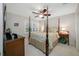 This bedroom features a four-poster bed, large window, and neutral color palette at 903 Pinellas Bayway S # 103, Tierra Verde, FL 33715