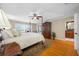 Comfortable bedroom with a four-poster bed, ceiling fan, and ensuite bathroom at 903 Pinellas Bayway S # 103, Tierra Verde, FL 33715