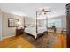 Spacious bedroom featuring a four-poster bed, hardwood floors, and shuttered windows at 903 Pinellas Bayway S # 103, Tierra Verde, FL 33715