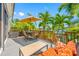 Relaxing deck area featuring comfortable seating, an umbrella, and picturesque water views at 903 Pinellas Bayway S # 103, Tierra Verde, FL 33715