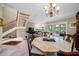 Dining area adjacent to living room shows marble floors, staircase, and natural light at 903 Pinellas Bayway S # 103, Tierra Verde, FL 33715