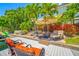 Waterfront home featuring a dock with lounge chairs and umbrella perfect for relaxing outdoors at 903 Pinellas Bayway S # 103, Tierra Verde, FL 33715