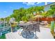 Waterfront dock with patio furniture and boat lift at 903 Pinellas Bayway S # 103, Tierra Verde, FL 33715