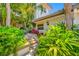 Beautiful entrance to home with lush landscaping and steps leading up to the door at 903 Pinellas Bayway S # 103, Tierra Verde, FL 33715