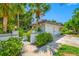 The front of the building with lush tropical landscaping and a red tiled roof at 903 Pinellas Bayway S # 103, Tierra Verde, FL 33715