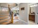 Open foyer with wood staircase that leads to living room and powder room at 903 Pinellas Bayway S # 103, Tierra Verde, FL 33715