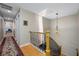 Hallway with hardwood floors, a skylight, staircase, and access to the main bedroom at 903 Pinellas Bayway S # 103, Tierra Verde, FL 33715