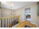 Bright hallway with wood floors, staircase, and entry to main bedroom at 903 Pinellas Bayway S # 103, Tierra Verde, FL 33715