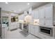 Gourmet kitchen boasts white cabinets, marble countertops, and stainless steel appliances at 903 Pinellas Bayway S # 103, Tierra Verde, FL 33715