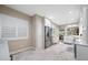 Bright kitchen with stainless steel refrigerator, white cabinets, marble countertops, and adjacent dining area at 903 Pinellas Bayway S # 103, Tierra Verde, FL 33715