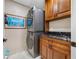 Laundry room with stacked washer and dryer, wooden cabinets, and granite countertop at 903 Pinellas Bayway S # 103, Tierra Verde, FL 33715