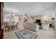 Inviting living room with a fireplace, staircase, and views into the dining room at 903 Pinellas Bayway S # 103, Tierra Verde, FL 33715