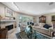 Cozy living room with fireplace, comfortable seating, and sliding doors to outdoor area at 903 Pinellas Bayway S # 103, Tierra Verde, FL 33715