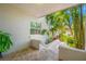 Covered patio featuring a tiled floor with tropical plants and trees at 903 Pinellas Bayway S # 103, Tierra Verde, FL 33715