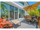 Outdoor patio with dining set and comfortable seating, overlooking the lush landscaping at 903 Pinellas Bayway S # 103, Tierra Verde, FL 33715