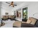 Bright sun room featuring comfortable seating and seamless access to the outdoor area through sliding doors at 903 Pinellas Bayway S # 103, Tierra Verde, FL 33715