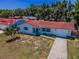 Aerial view showcasing the red tile roof, long driveway, and landscaping surrounding this cozy single-story home at 9952 111Th St, Seminole, FL 33772