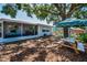 Relaxing backyard with picnic table and screened-in porch in view of stock tank pool, for lounging and entertaining at 9952 111Th St, Seminole, FL 33772