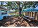 Spacious backyard features a picnic bench, seating, and a large tree, creating a peaceful outdoor area at 9952 111Th St, Seminole, FL 33772