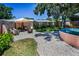 Backyard oasis featuring gravel, seating area with fire pit, and a stock tank pool for relaxation and entertainment at 9952 111Th St, Seminole, FL 33772
