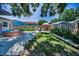 Charming backyard with a stock tank pool, fire pit, and seating, ideal for outdoor relaxation and entertaining at 9952 111Th St, Seminole, FL 33772