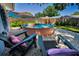 Inviting backyard featuring a unique stock tank pool, lounge chairs, privacy fence, and a charming pebble landscape at 9952 111Th St, Seminole, FL 33772