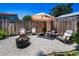 Cozy backyard with fire pit, seating area, decorative umbrella, string lights, and a privacy fence at 9952 111Th St, Seminole, FL 33772