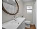 Bathroom features a large mirror, modern sink, and toilet against a neutral color scheme at 9952 111Th St, Seminole, FL 33772
