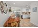 Eat-in kitchen and dining area features a rustic table, chairs and white cabinets at 9952 111Th St, Seminole, FL 33772