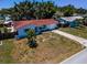 Charming single-story home featuring a red tile roof, a well-manicured lawn, and a quaint front yard at 9952 111Th St, Seminole, FL 33772